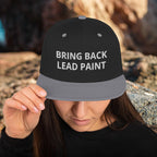 High quality black-silver embroidery on 'Bring Back Lead Paint' snapback. Flat visor view