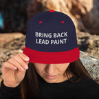 High quality navy-red embroidery on 'Bring Back Lead Paint' snapback. Flat visor view